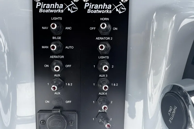 Slide: The Image of Control panel of 2026 Piranha Casador B2200 boat with various switches and labels. - 20