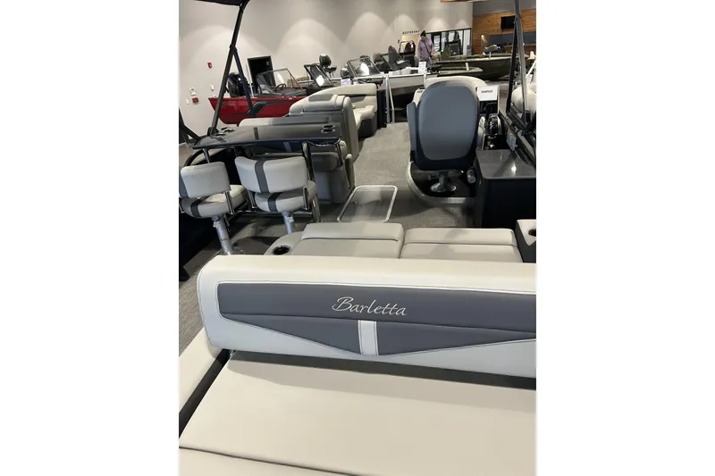 Slide: The Image of 2025 Barletta C24UE pontoon boat interior with stylish seating and helm. - 9