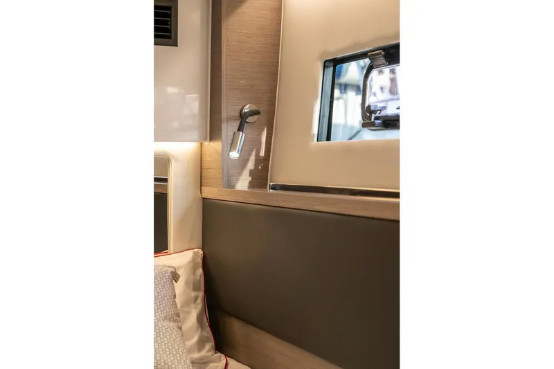 Slide: The Image of Interior of 2026 Jeanneau NC1295 Coupe, featuring modern lighting and window detail. - 11