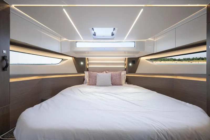 Slide: The Image of Luxurious bedroom interior of 2026 Jeanneau NC1295 Coupe yacht with modern lighting. - 9