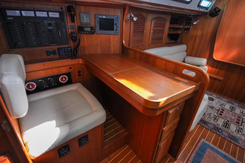 Slide: The Image of 2004 Sabre 426 yacht interior with navigation station and wooden cabinetry. - 102