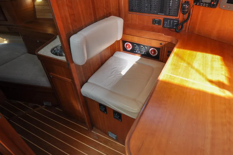 Slide: The Image of Interior of 2004 Sabre 426 yacht with wooden finish and cushioned seating. - 104