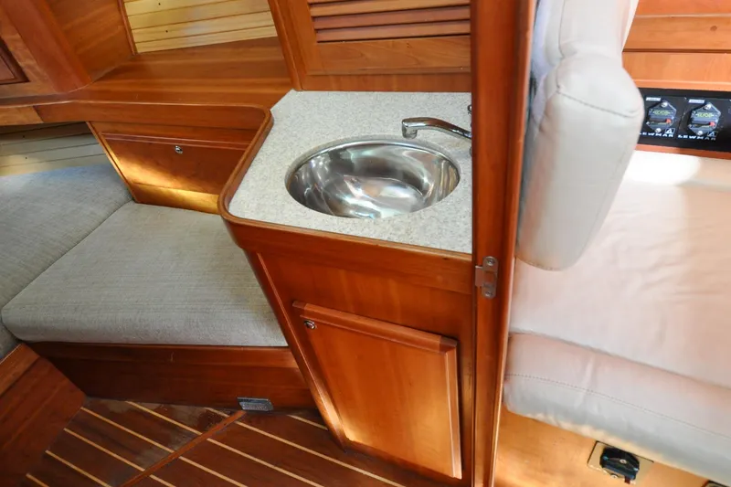 Slide: The Image of Interior of 2004 Sabre 426 yacht with wooden cabinetry and compact sink. - 107