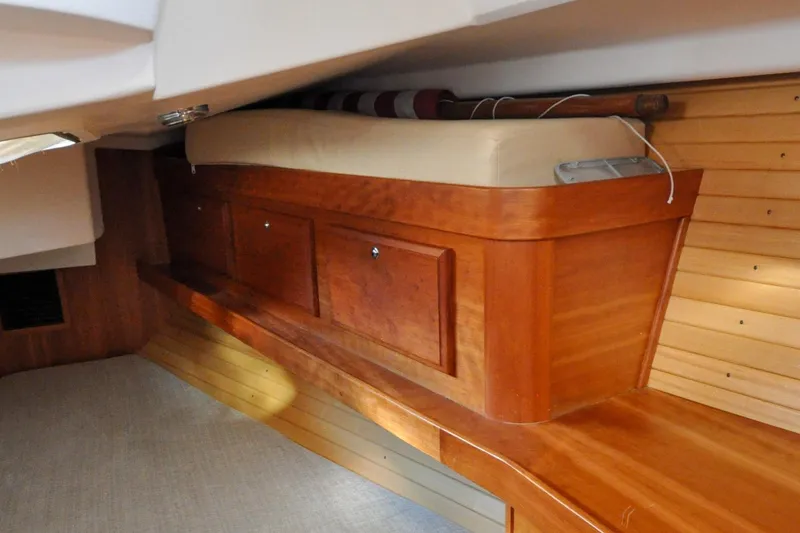 Slide: The Image of 2004 Sabre 426 interior with wooden cabinetry and cushioned seating. - 109