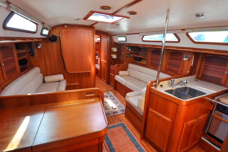 Slide: The Image of Luxurious 2004 Sabre 426 yacht interior with wooden finish, cozy seating, and modern kitchen amenities. - 114
