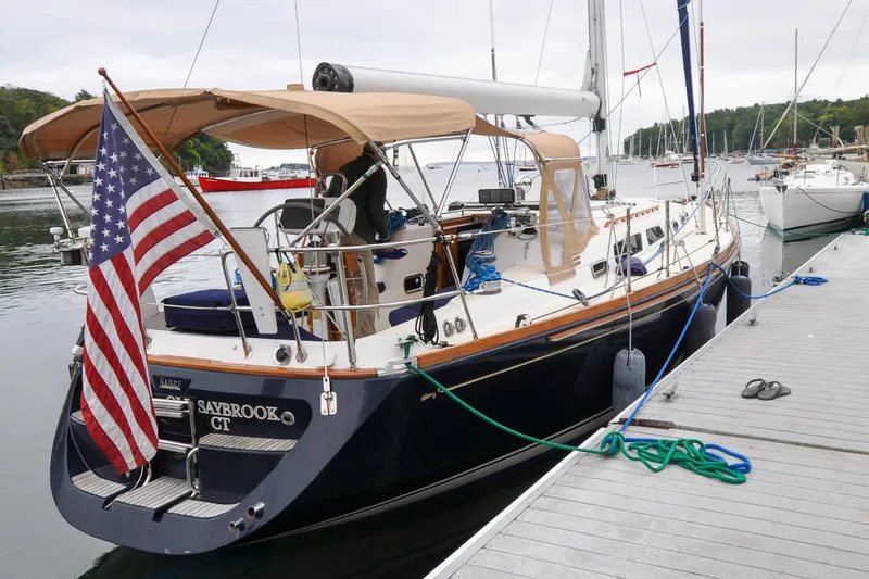 Slide: The Image of Sabre 426 sailboat docked, displaying American flag, Saybrook CT, 2004 model. - 3