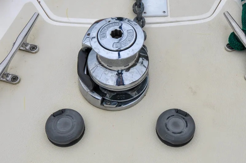 Slide: The Image of Chrome winch on 2004 Sabre 426 yacht deck with cleats and chain. - 40