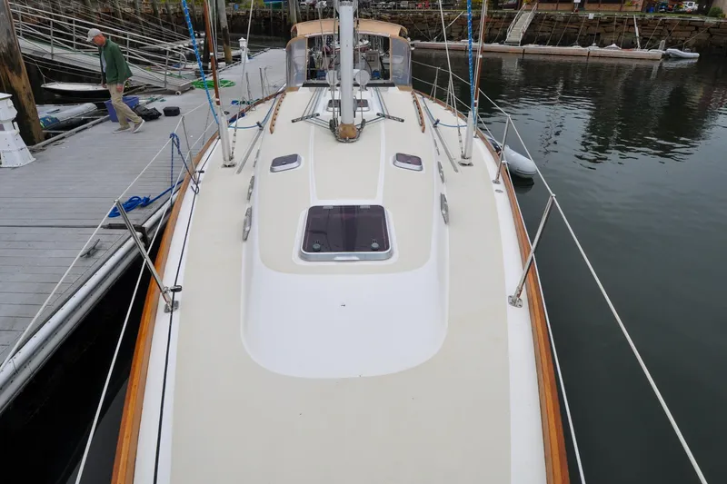 Slide: The Image of 2004 Sabre 426 sailboat docked, featuring a clean deck and visible rigging. - 42