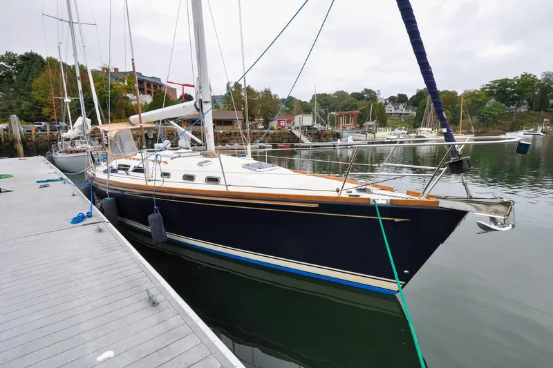 Slide: The Image of Sailboat Sabre 426, 2004 model, docked at a marina with scenic background. - 5