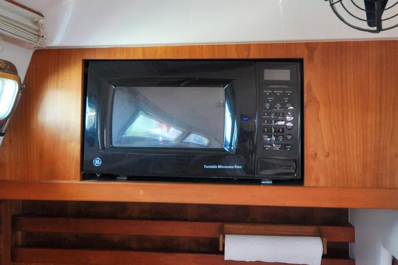 Slide: The Image of Black GE microwave in wooden cabinet on 2004 Sabre 426 yacht. - 50
