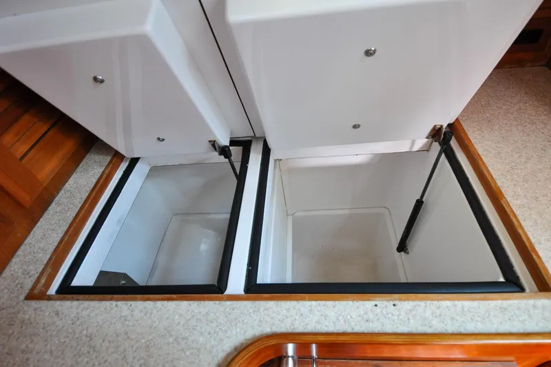 Slide: The Image of Open storage compartments on a 2004 Sabre 426 boat interior. - 51