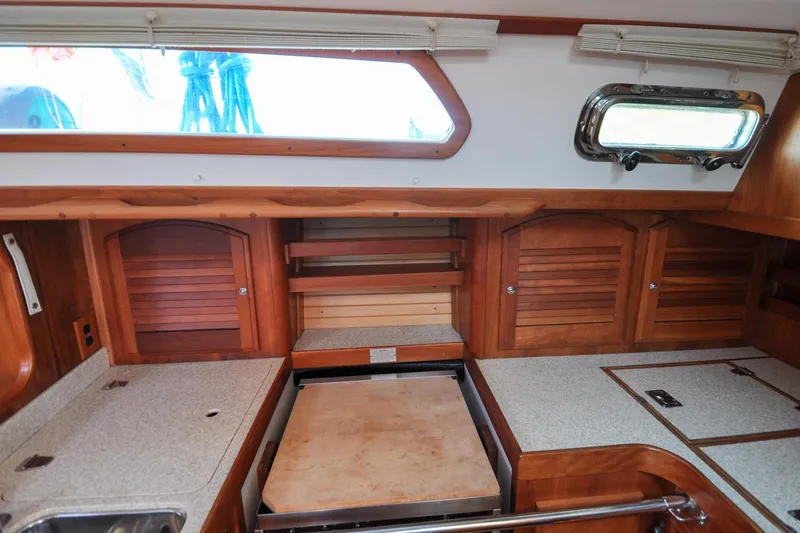 Slide: The Image of 2004 Sabre 426 yacht interior with wooden cabinets and countertop. - 53