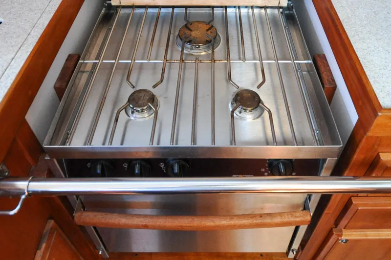 Slide: The Image of Three-burner stainless steel stove in a 2004 Sabre 426 yacht kitchen. - 55