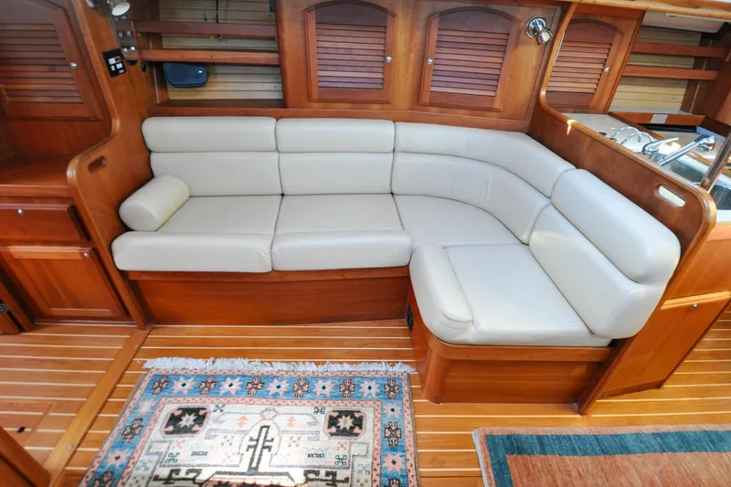Slide: The Image of Luxurious 2004 Sabre 426 yacht interior with plush seating and elegant wooden finishes. - 65