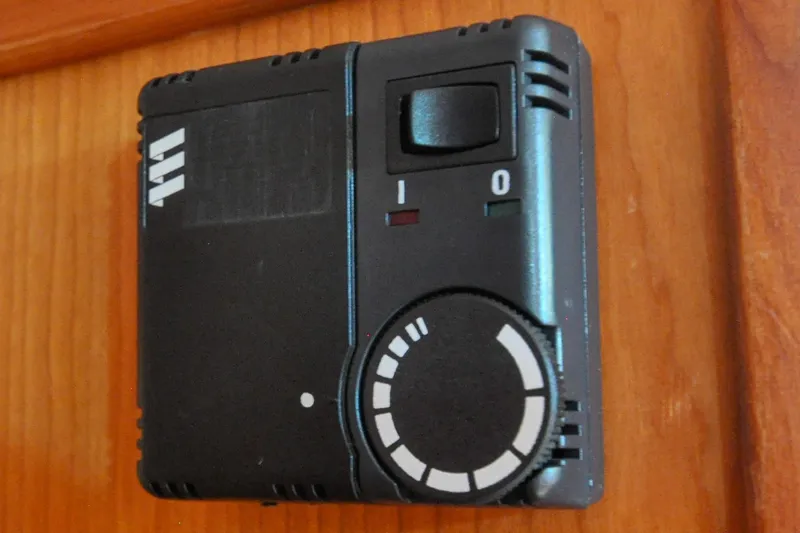 Slide: The Image of Black control panel with dial and switch, Sabre 426 model, 2004, mounted on wooden surface. - 67