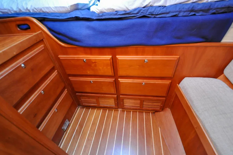 Slide: The Image of Wooden cabinetry and flooring in 2004 Sabre 426 interior, featuring ample storage space. - 70