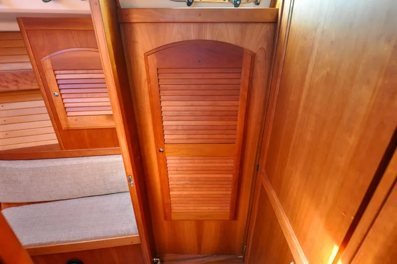 Slide: The Image of 2004 Sabre 426 interior with wooden cabinetry and cushioned seating. - 72
