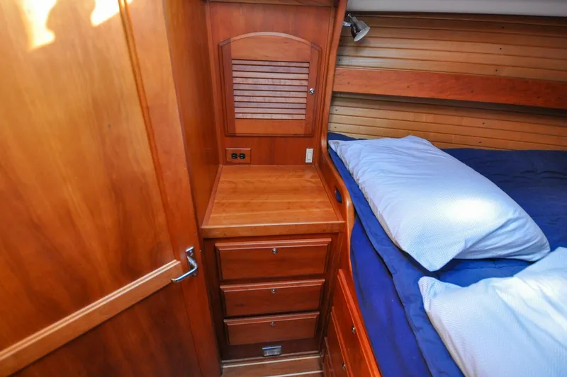 Slide: The Image of Wooden cabin interior of 2004 Sabre 426 yacht with bed and storage drawers. - 78