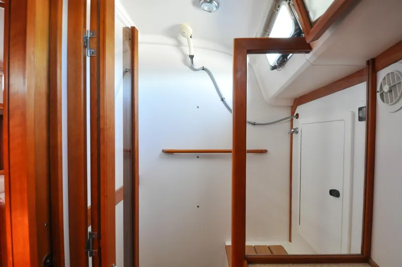 Slide: The Image of 2004 Sabre 426 yacht interior with wooden trim and white walls. - 85