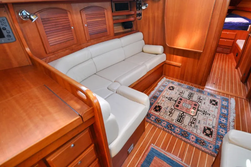 Slide: The Image of Luxurious 2004 Sabre 426 yacht interior with elegant wood finish and cozy seating area. - 90