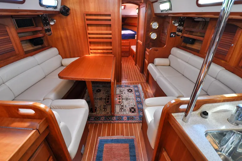 Slide: The Image of Luxurious 2004 Sabre 426 yacht interior with wooden finish and comfortable seating. - 92