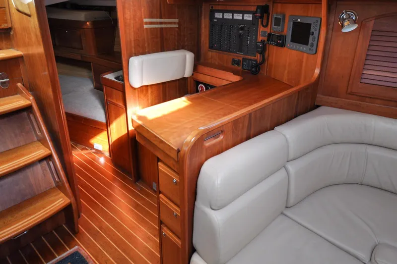 Slide: The Image of Luxurious 2004 Sabre 426 yacht interior with wood finish and navigation station. - 94