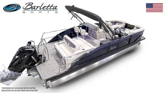 Slide: The Image of 2025 Barletta Boats C24UE pontoon with sleek design and modern features, displayed with American flag. - 4