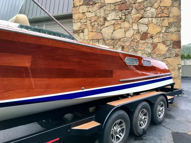 Slide: The Image of Custom 2020 Windlea Runabout boat with polished wood finish on a trailer. - 27