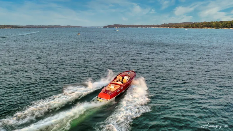 Slide: The Image of Aerial view of 2020 Custom Windlea Runabout speedboat cruising on a scenic lake. - 36