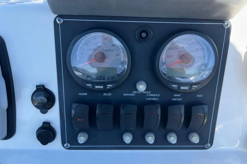 Slide: The Image of Dashboard of a 2009 Boston Whaler 180 Dauntless boat with gauges and switches. - 16
