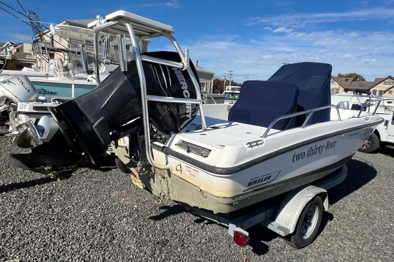 Slide: The Image of 2009 Boston Whaler 180 Dauntless boat on trailer, featuring Mercury outboard motor. - 5