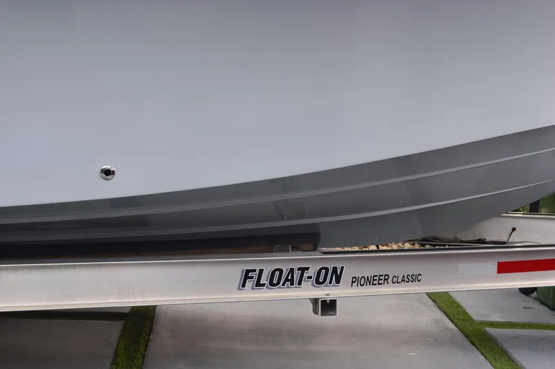 Slide: The Image of 2022 Aquasport 2300 Center Console boat on trailer with American flag tire cover. - 13