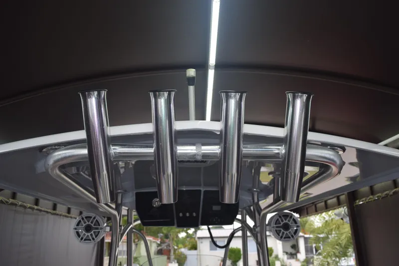 Slide: The Image of 2022 Aquasport 2300 Center Console boat with stainless steel rod holders and speakers. - 16