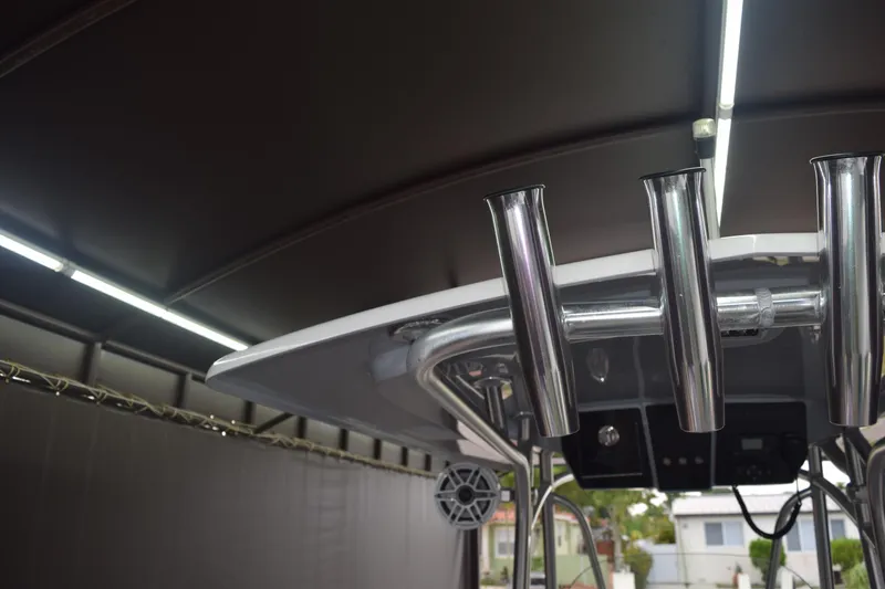 Slide: The Image of 2022 Aquasport 2300 Center Console boat with rod holders and speaker system. - 17