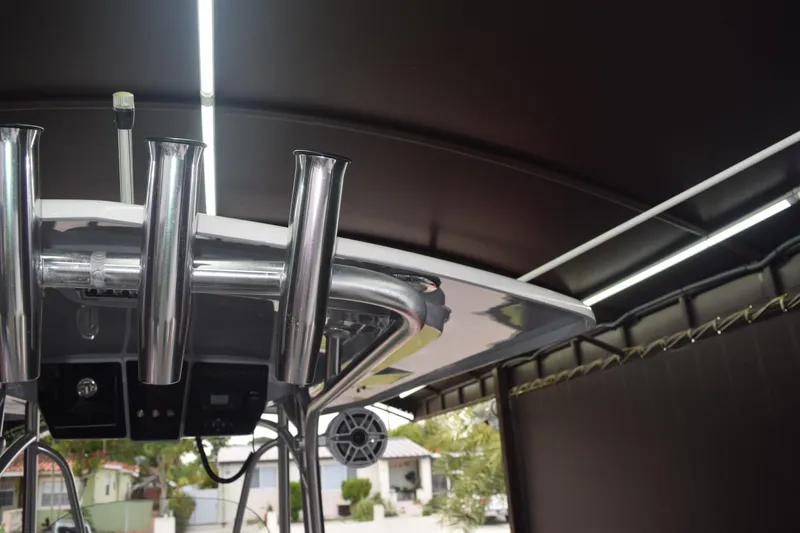 Slide: The Image of 2022 Aquasport 2300 Center Console boat with rod holders and canopy. - 18