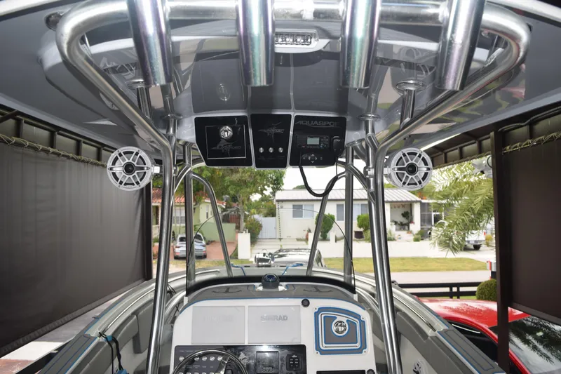 Slide: The Image of 2022 Aquasport 2300 Center Console boat interior with speakers and control panel. - 19
