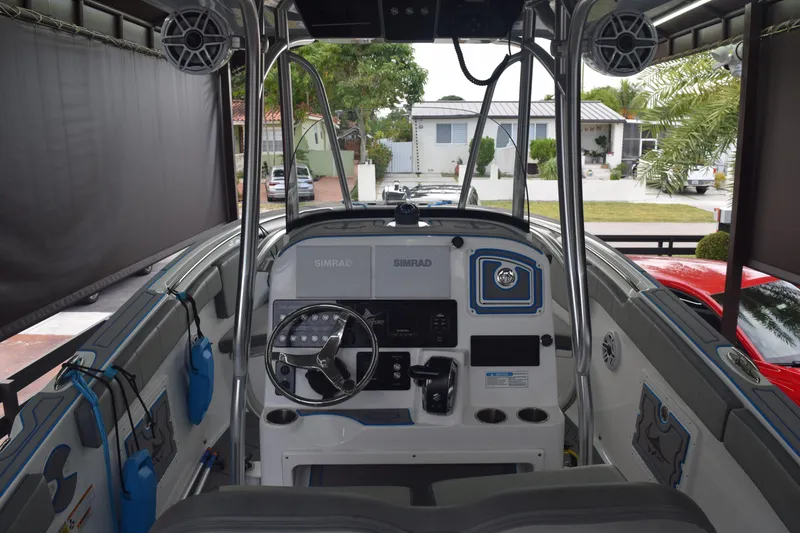 Slide: The Image of 2022 Aquasport 2300 Center Console boat interior with steering wheel and control panel. - 20