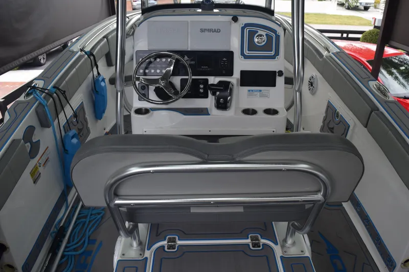 Slide: The Image of 2022 Aquasport 2300 Center Console boat interior with steering wheel and seating. - 21
