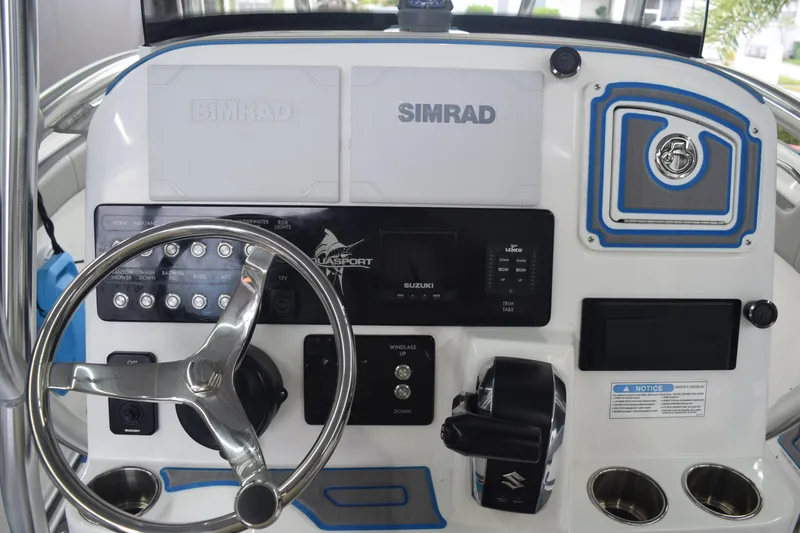 Slide: The Image of 2022 Aquasport 2300 Center Console dashboard with steering wheel and controls. - 23