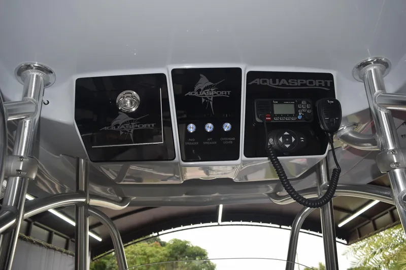 Slide: The Image of 2022 Aquasport 2300 Center Console dashboard with controls and communication equipment. - 32