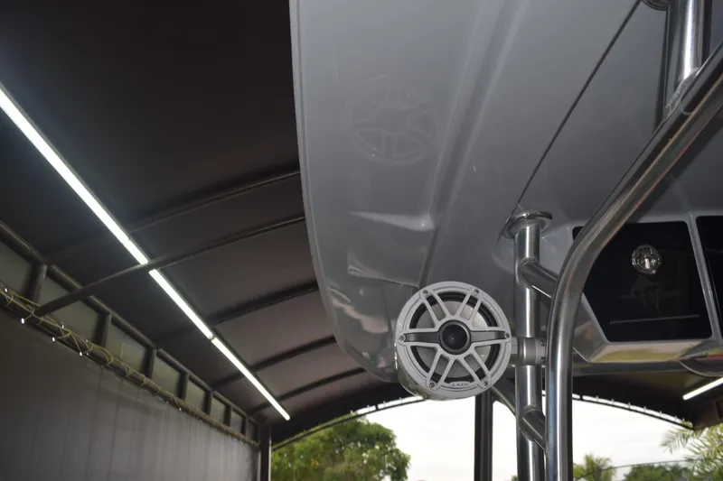 Slide: The Image of 2022 Aquasport 2300 Center Console boat with speaker and canopy detail. - 37