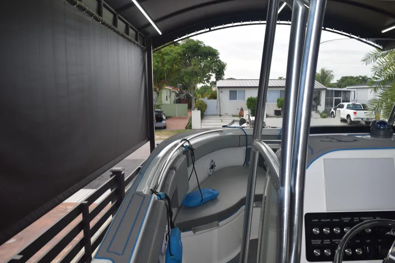Slide: The Image of 2022 Aquasport 2300 Center Console boat interior under a covered area. - 38