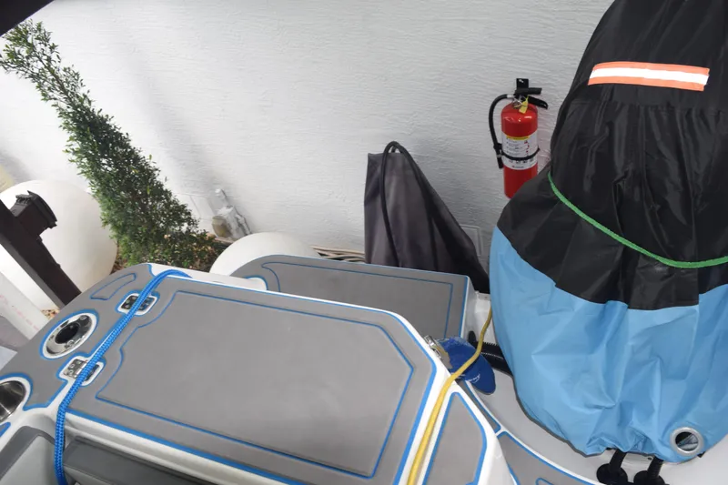 Slide: The Image of 2022 Aquasport 2300 Center Console boat interior with safety equipment and cover. - 43