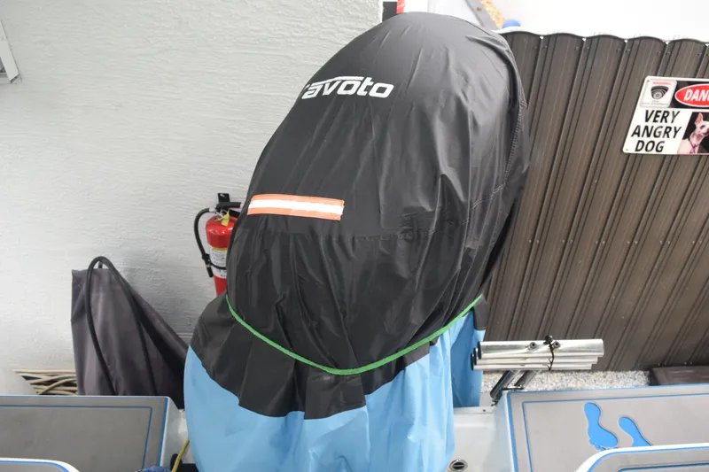 Slide: The Image of 2022 Aquasport 2300 Center Console with covered outboard motor and safety equipment. - 44