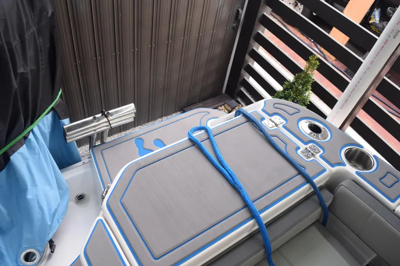 Slide: The Image of 2022 Aquasport 2300 Center Console boat interior with blue accents and rope. - 45