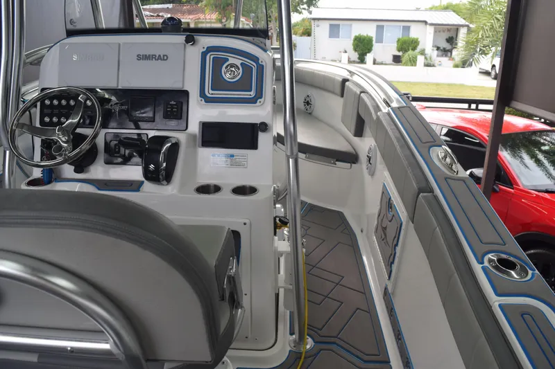 Slide: The Image of 2022 Aquasport 2300 Center Console boat interior with steering wheel and seating. - 46