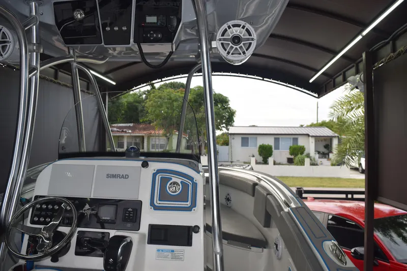 Slide: The Image of 2022 Aquasport 2300 Center Console boat interior with steering and control panel. - 47