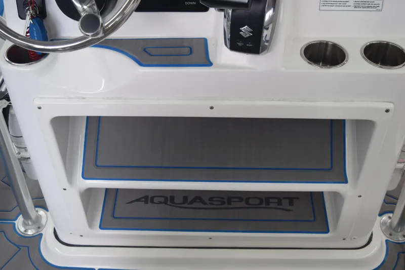 Slide: The Image of 2022 Aquasport 2300 Center Console dashboard with steering wheel and cup holders. - 50