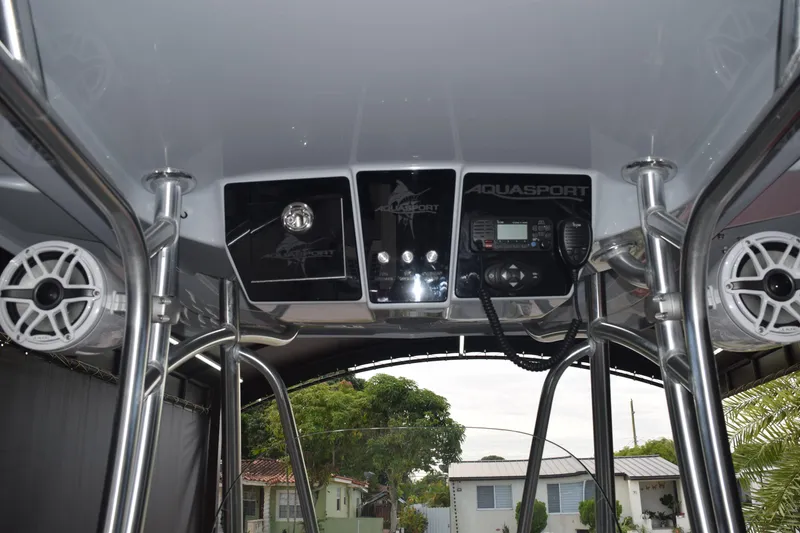 Slide: The Image of 2022 Aquasport 2300 Center Console dashboard with speakers and control panel. - 52