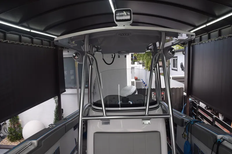 Slide: The Image of 2022 Aquasport 2300 Center Console boat under a covered dock. - 54